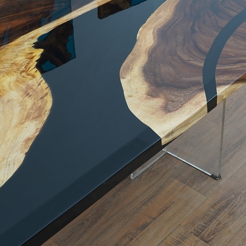 A handcrafted black epoxy resin river table with live edge wood, made from high-quality raw materials, perfect for dining or office use.