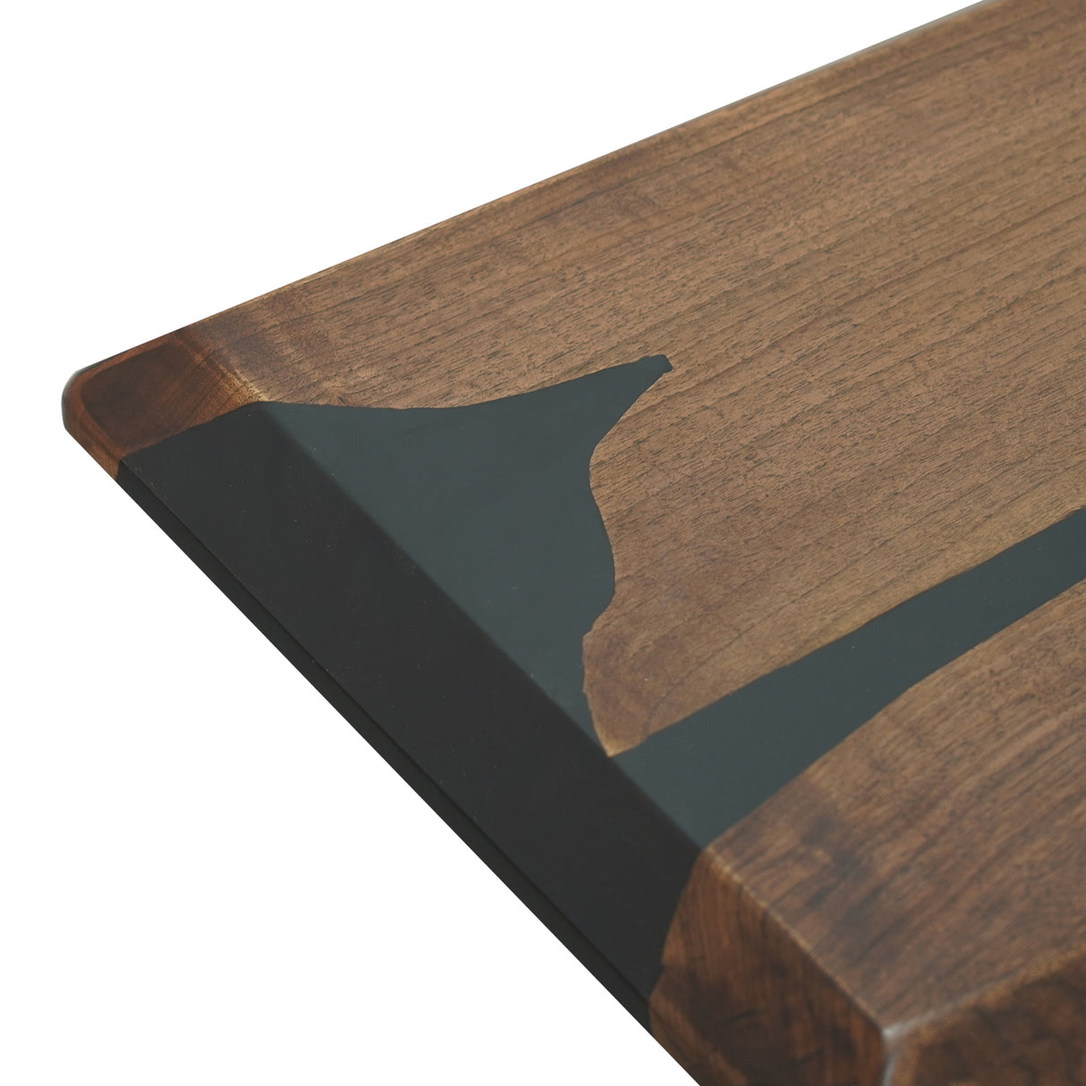 Close - up of a wooden tabletop with an inlaid black epoxy resin design.
