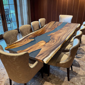 Handmade live edge epoxy resin dining table with natural wood slab and acrylic legs, perfect for modern interiors.