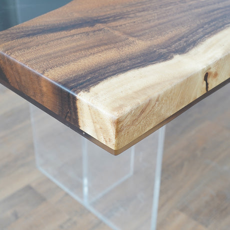 Handmade live edge epoxy resin dining table with natural wood slab and acrylic legs, perfect for modern interiors.