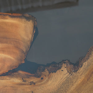 Handmade live edge epoxy resin dining table with natural wood slab and acrylic legs, perfect for modern interiors.