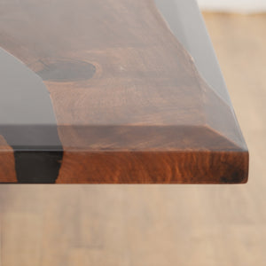 A luxury handcrafted epoxy river dining table made from solid wood and high-gloss resin, featuring a modern design with acrylic legs.