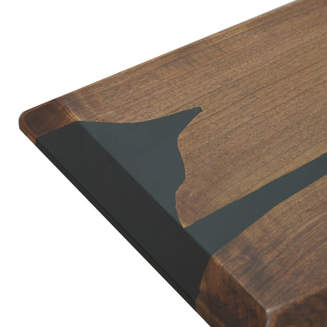 Close - up of a wooden tabletop with an inlaid black epoxy resin design.