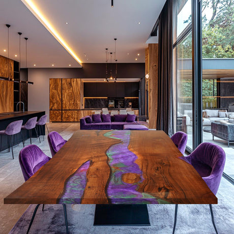 A large rectangular epoxy - resin and wood dining table with a vibrant purple and green resin inlay, surrounded by purple velvet chairs, set in a modern, well - lit open - plan living and dining space.