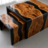 Olive wood and black epoxy resin waterfall coffee table with continuous wood grain flowing seamlessly from the tabletop down the sides