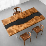 Golden camphor live edge dining table with a flowing black epoxy resin river and beautifully figured natural wood slabs