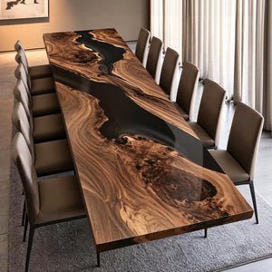 Handcrafted black walnut conference table featuring a flowing black epoxy resin river, dramatic natural wood grain, and a smooth polished finish