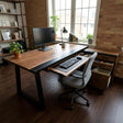Black walnut office desk with a matte black resin inlay, pull-out keyboard tray, and storage drawers