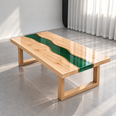 Custom ash wood epoxy river coffee table combining a rich green resin center with beautifully figured light wood slabs and minimalist styling