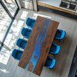 A straight-edge coffee table with a rich wooden surface interspersed with vibrant blue epoxy-resin