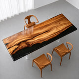 High-gloss olive wood conference tabletop featuring flowing natural grain patterns, a reflective black resin section, and warm honey brown tones