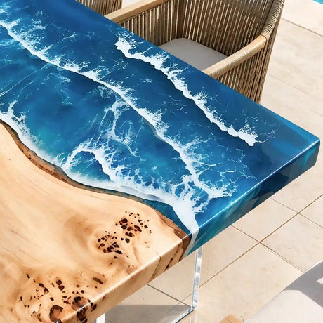 Luxury coastal dining table featuring natural poplar live edge wood, deep blue ocean resin, and elegant woven patio chairs