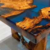 Modern statement table combining olive wood burl and reflective blue resin