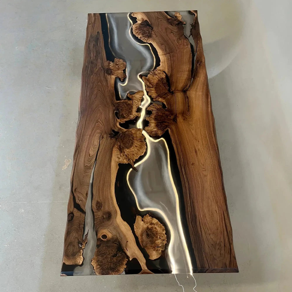 Modern organic dining table crafted from solid wood and glossy black resin
