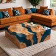 Handcrafted olive wood coffee table featuring deep blue epoxy resin, intricate natural wood grain, and a stunning high-gloss finish