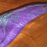 Surrounding the table are luxurious purple velvet chairs, adding a touch of opulence and comfort