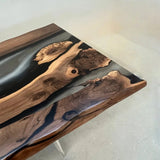 Sculptural wood and resin dining table paired with three minimalist wooden chairs