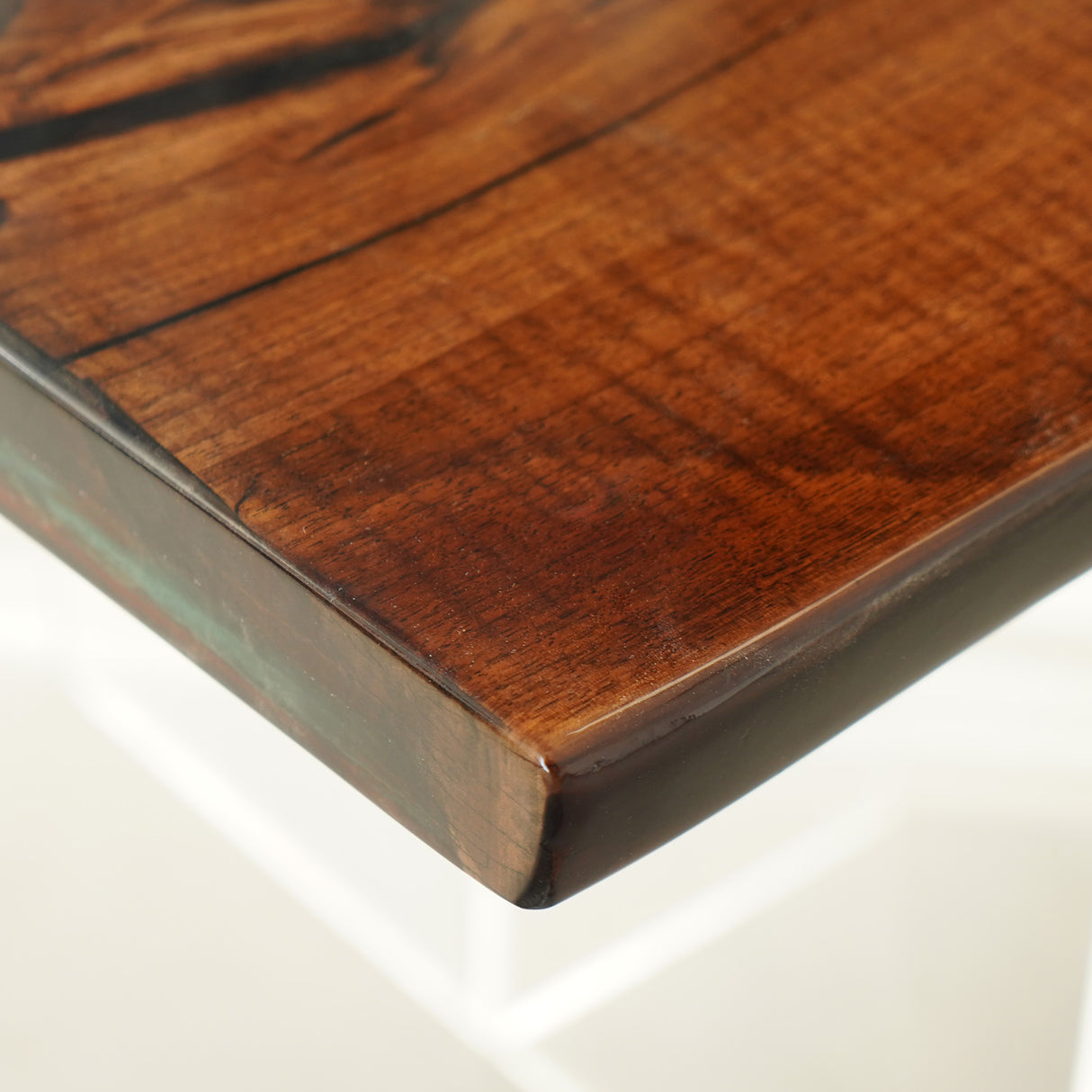 The rich, warm tones of the wood provide a beautiful contrast to the vivid colors of the resin.