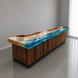 Handcrafted walnut wood reception desk featuring vibrant turquoise blue ocean wave epoxy resin, rich natural wood grain, and a glossy finish