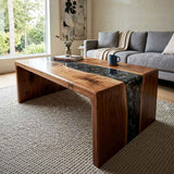 Walnut-tone wood coffee table with a dramatic black resin inlay in a modern living room